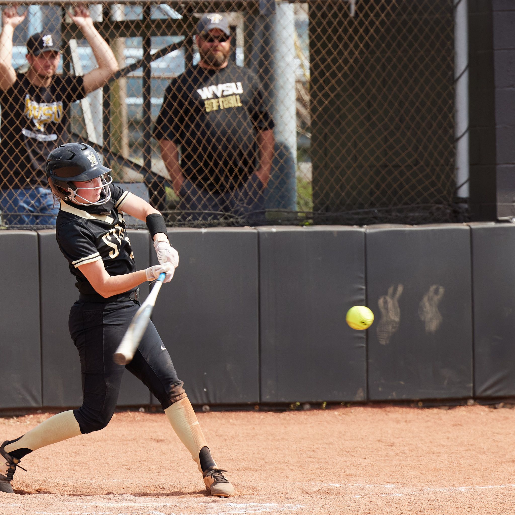 A West Virginia State University softball player takes a hard swing at the ball against Charleston.